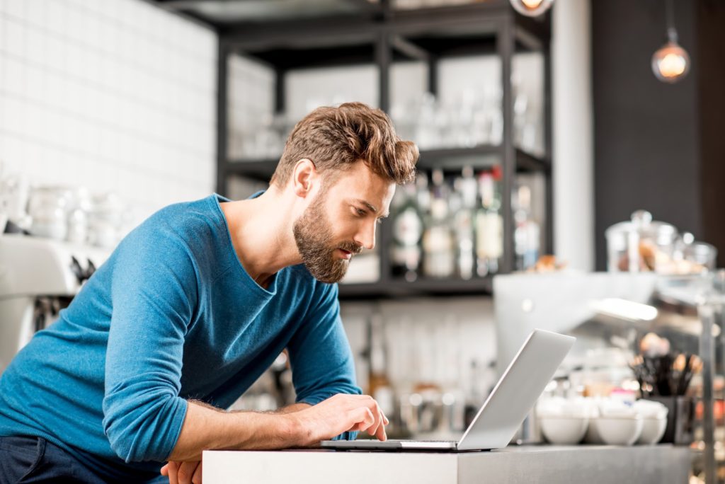 How to market your business: Man at laptop working on his website