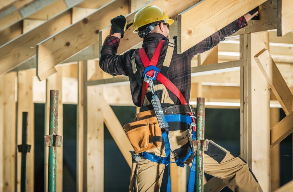 Construction worker building a housing wood frame