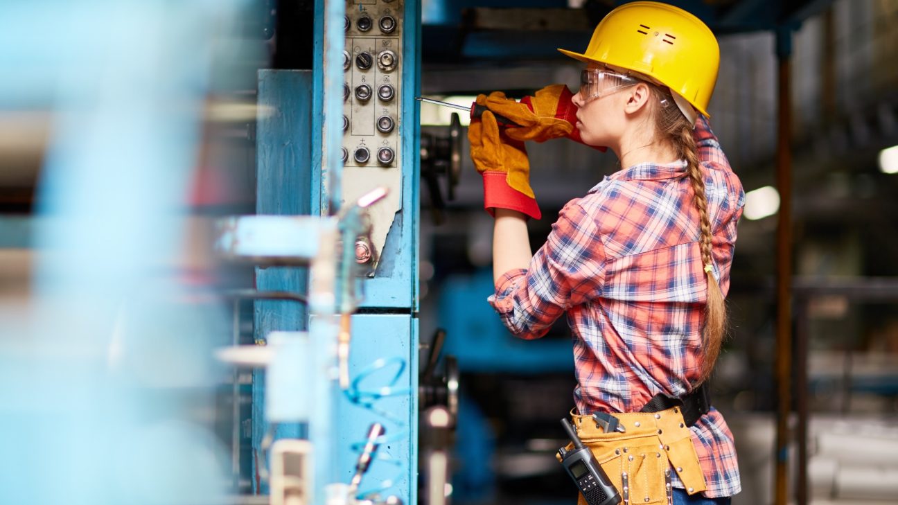 Electrician advertising: Female electrician with hard hat and gloves
