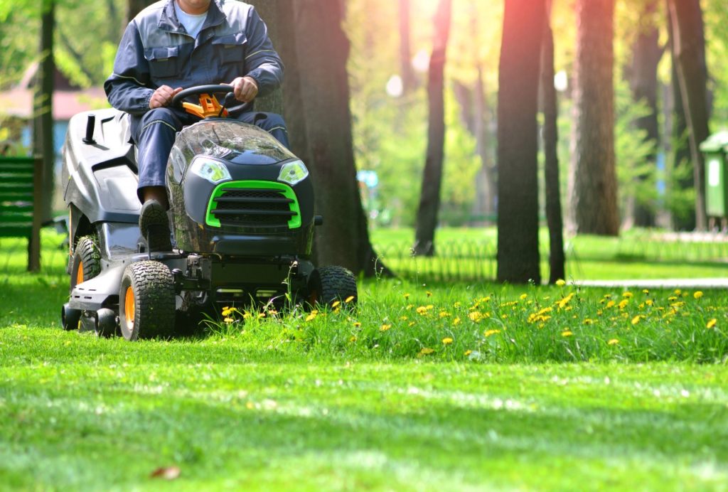 Man on electric mower: how to start a landscaping business