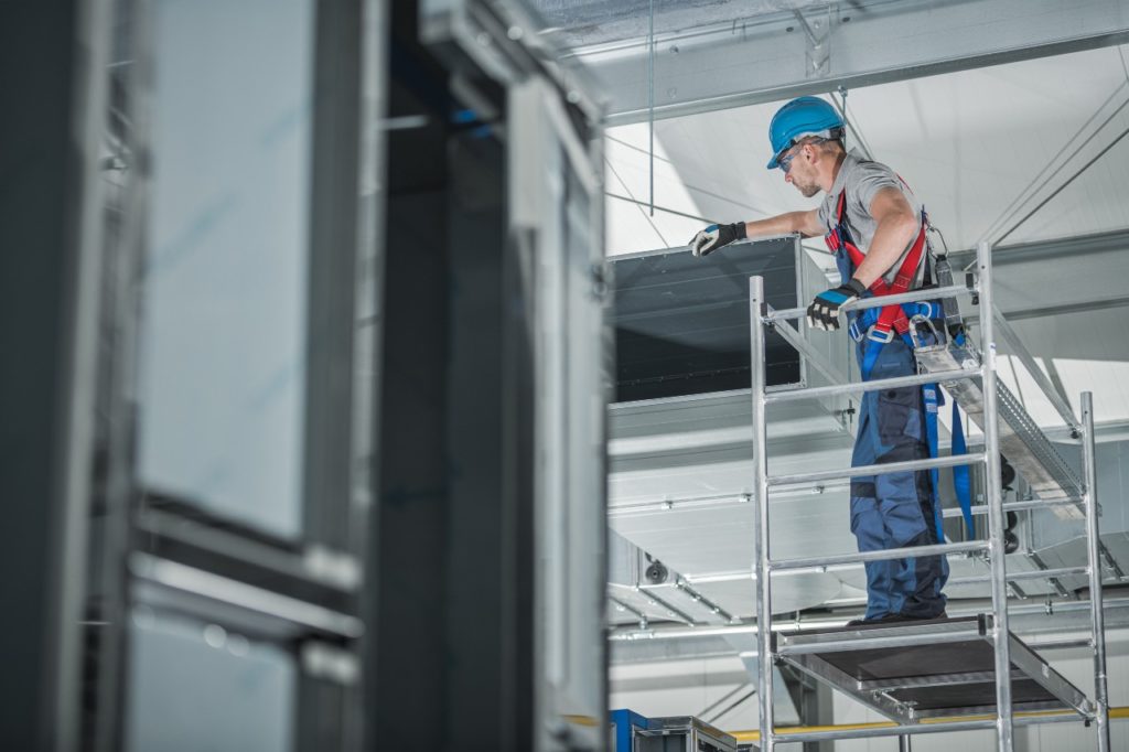 Starting an HVAC business: Worker on scaffolding