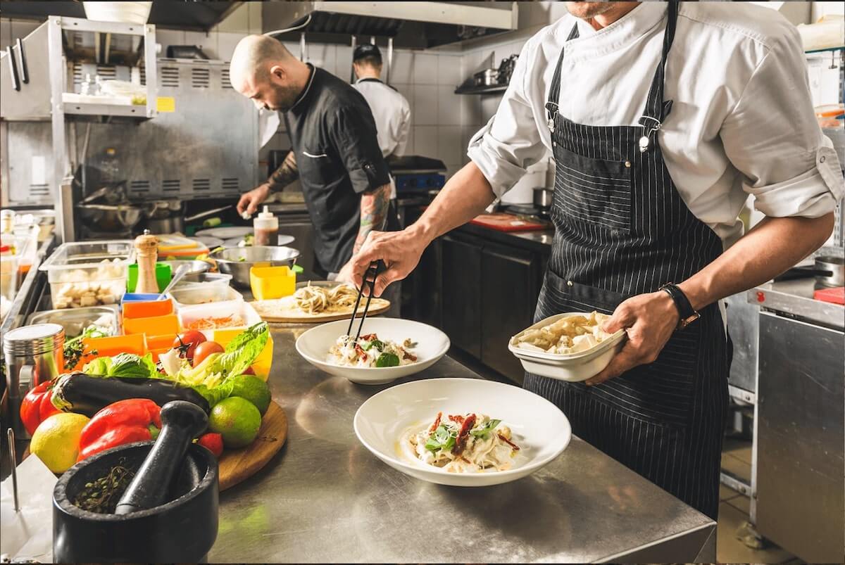 Opening a restaurant: chefs preparing meals