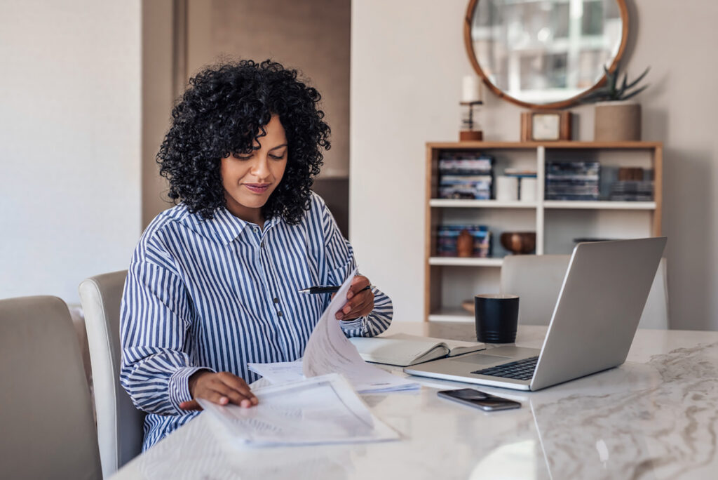 Woman looking at paperwork in a home office