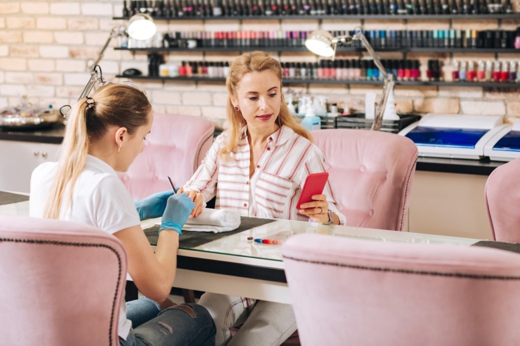 Nail salon business plan: Woman getting her nails done
