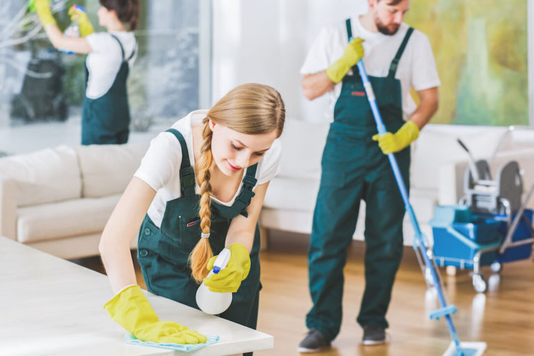 How to market a cleaning business: team of cleaners cleaning a living room