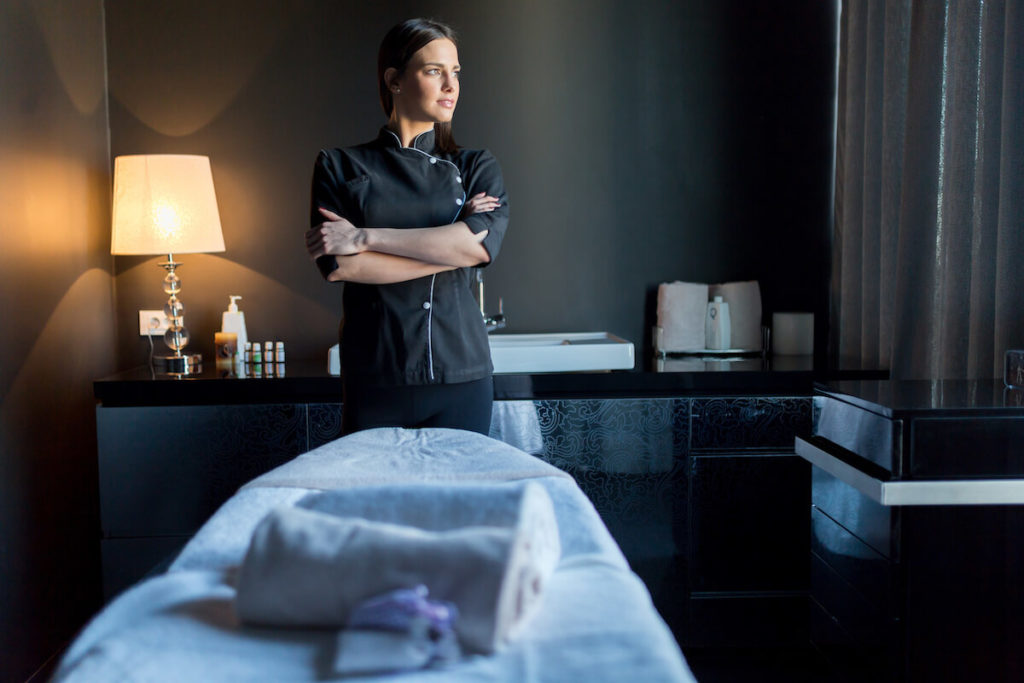 Massage therapy business plan: massage therapist standing in her spa