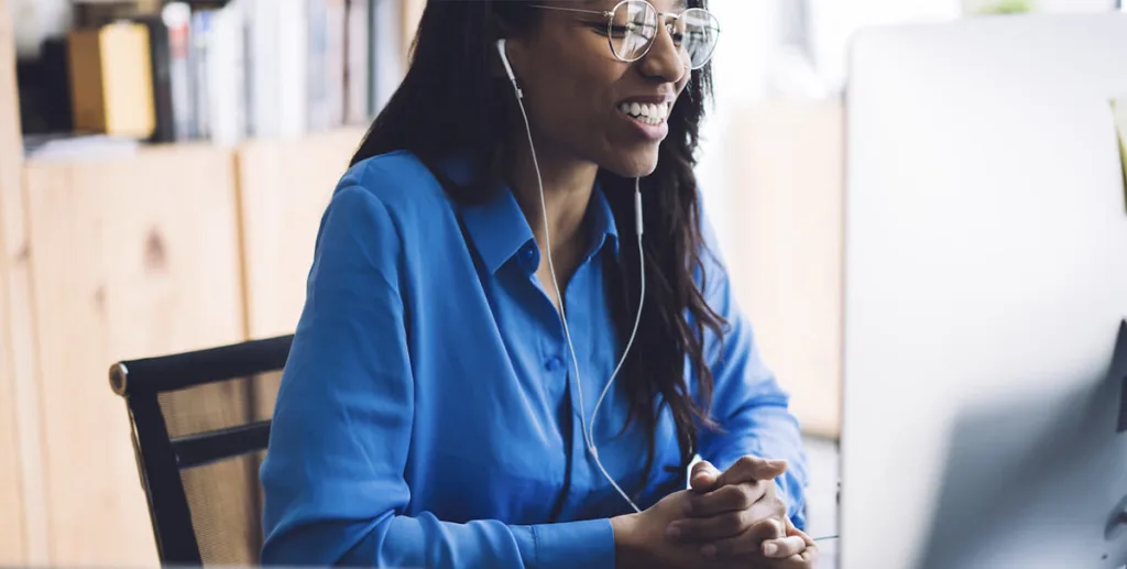 How to write a press release: happy woman in a virtual meeting