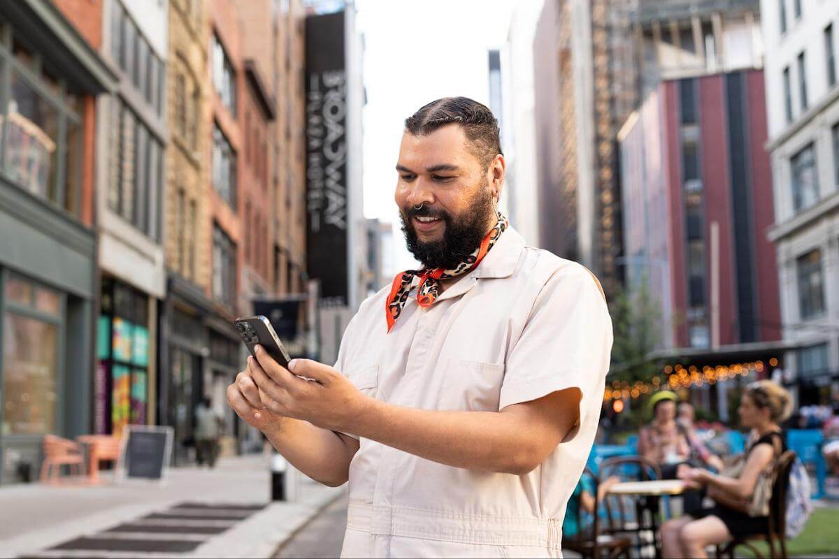 Person smiling while using his phone