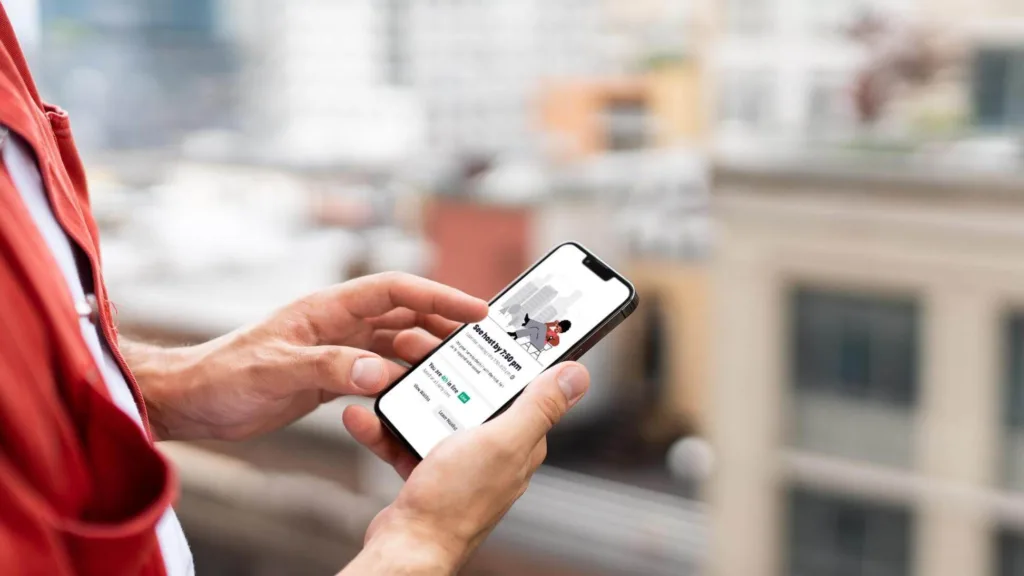 Third-party delivery services: person checking his delivery via a mobile app
