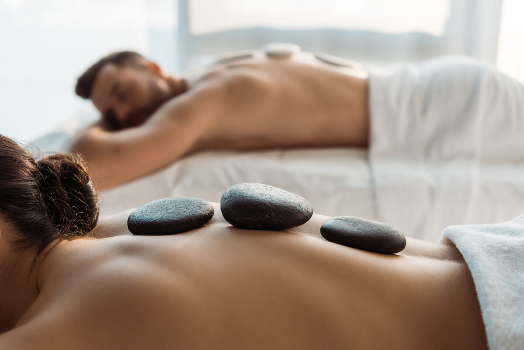 How to start a spa business: couple getting a hot stone massage