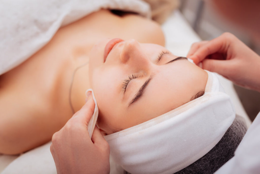 How to start a spa business: woman getting a facial