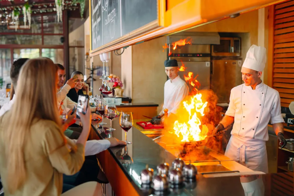 Customers watching a chef cook
