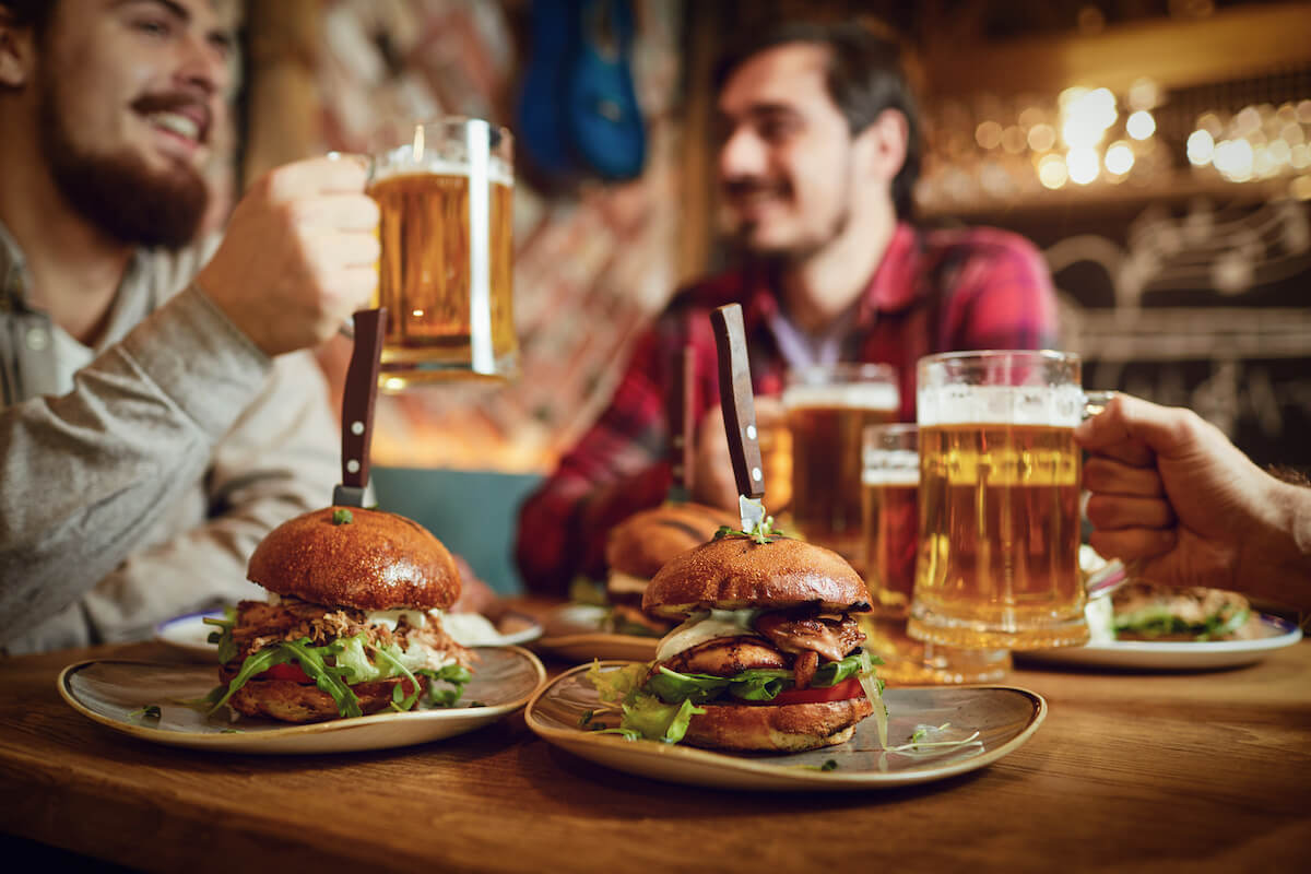Group of friends eating and drinking at a restaurant