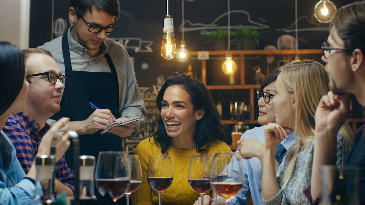 How to get a liquor license: group of friends ordering at a restaurant