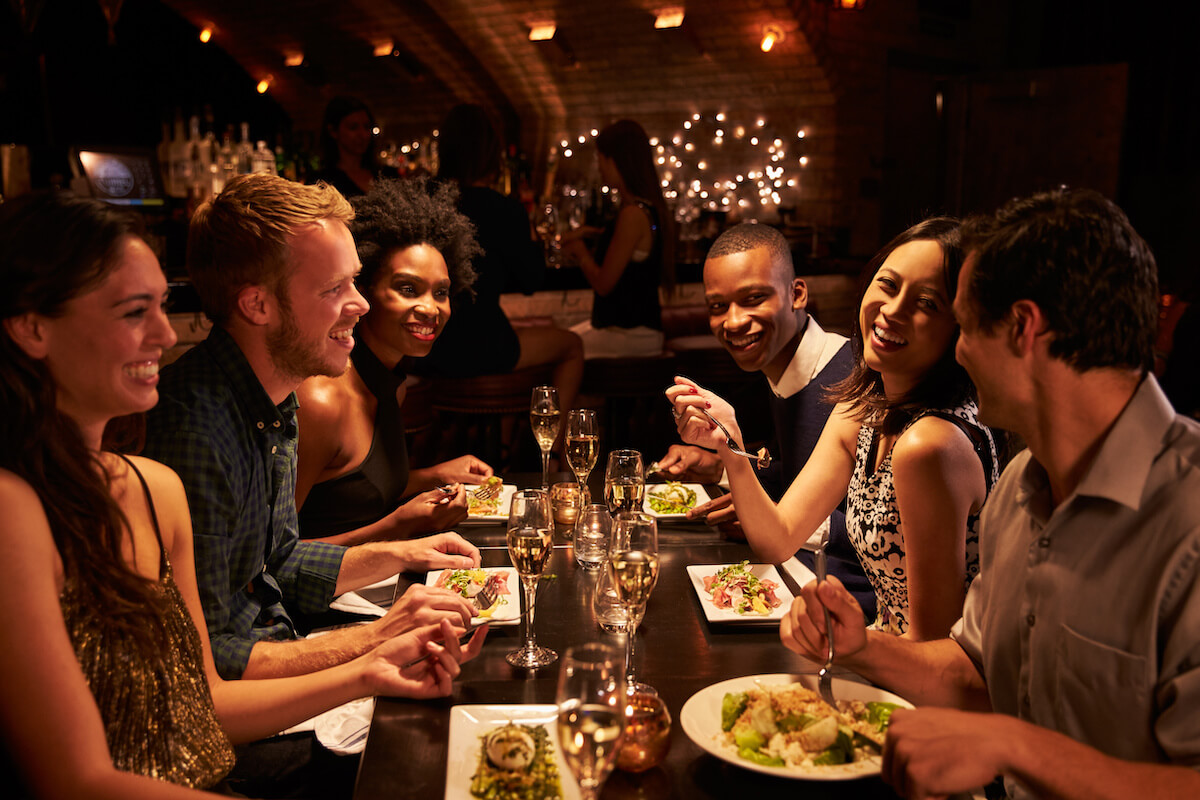 Group of friends talking and drinking at a restaurant