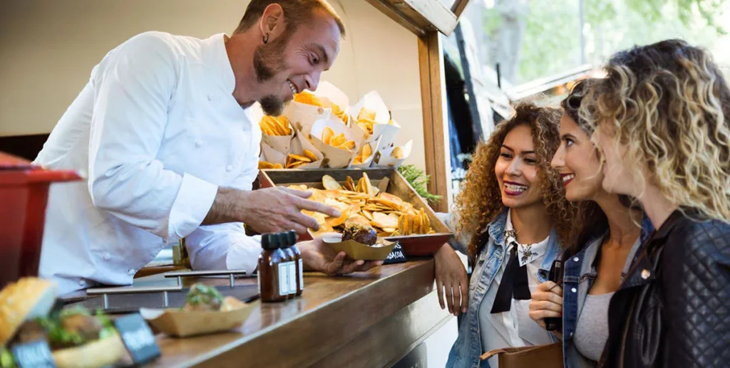 How to start a food truck business: food truck owner serving customers