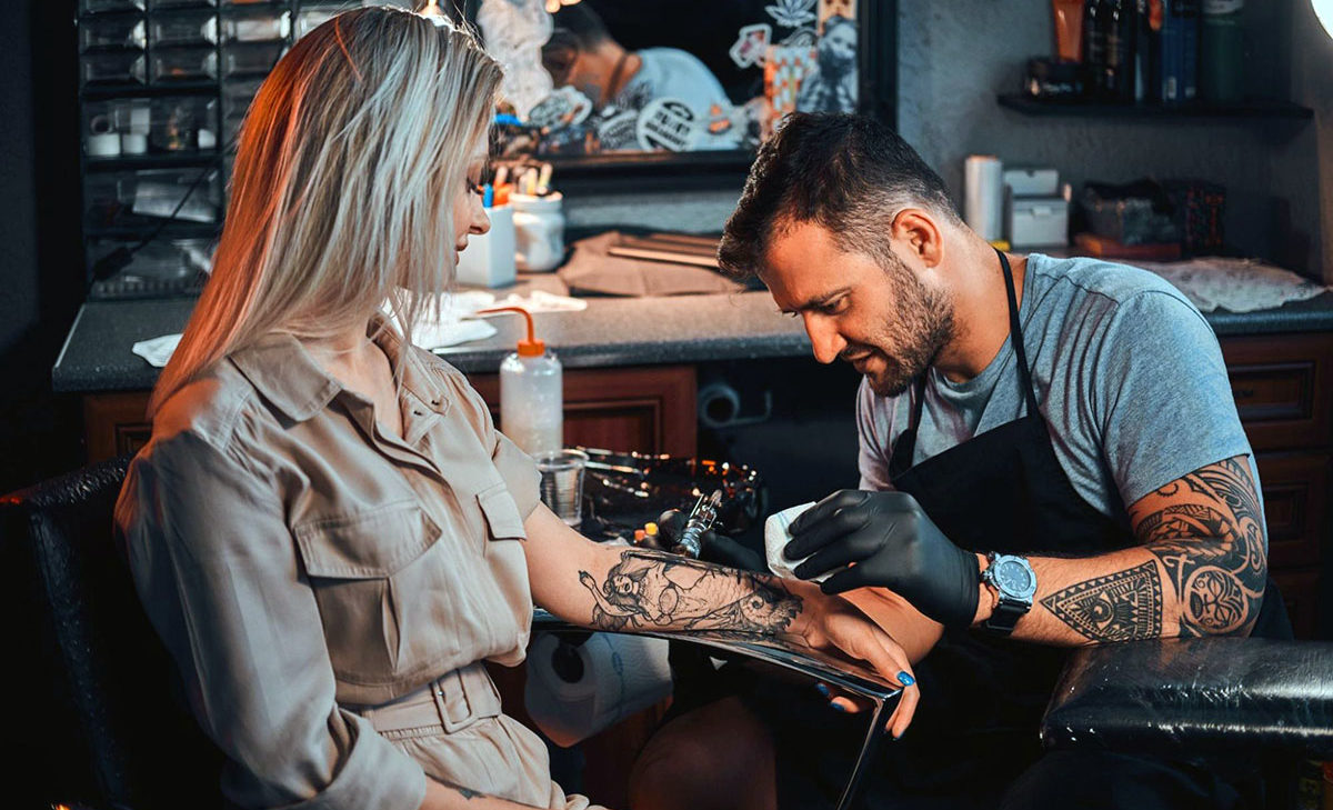 lp-ban-woman-getting-arm-tattoo