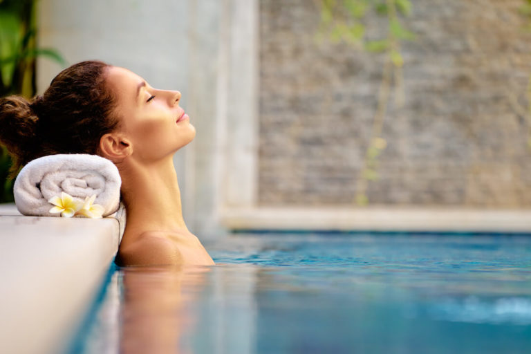 Spa marketing ideas: woman relaxing in a pool