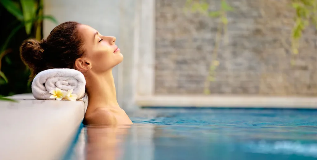 Spa marketing ideas: woman relaxing in a pool