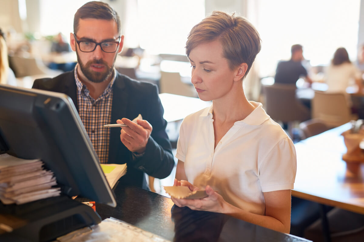 Manager talking to staff member about restaurant standards