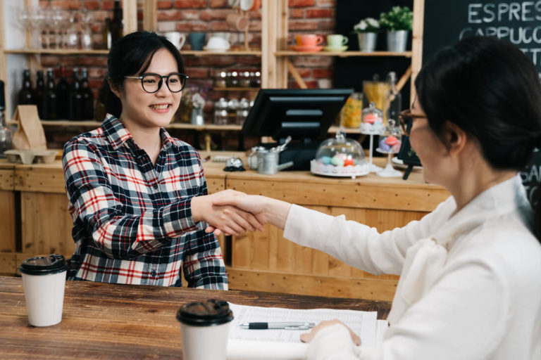 Recruitment strategies: applicant shaking hands with an employee