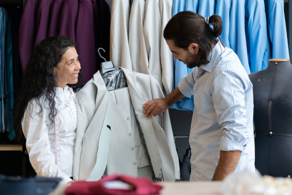 Entrepreneur showing her customer a suit