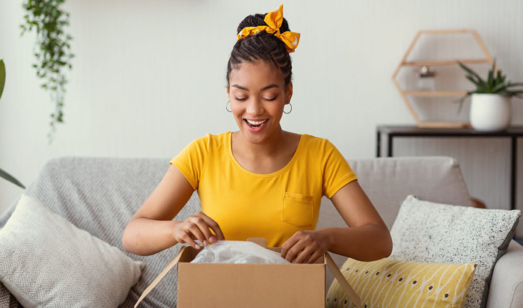 Woman opening a box at home