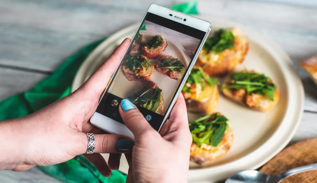 Person taking a photo of a meal