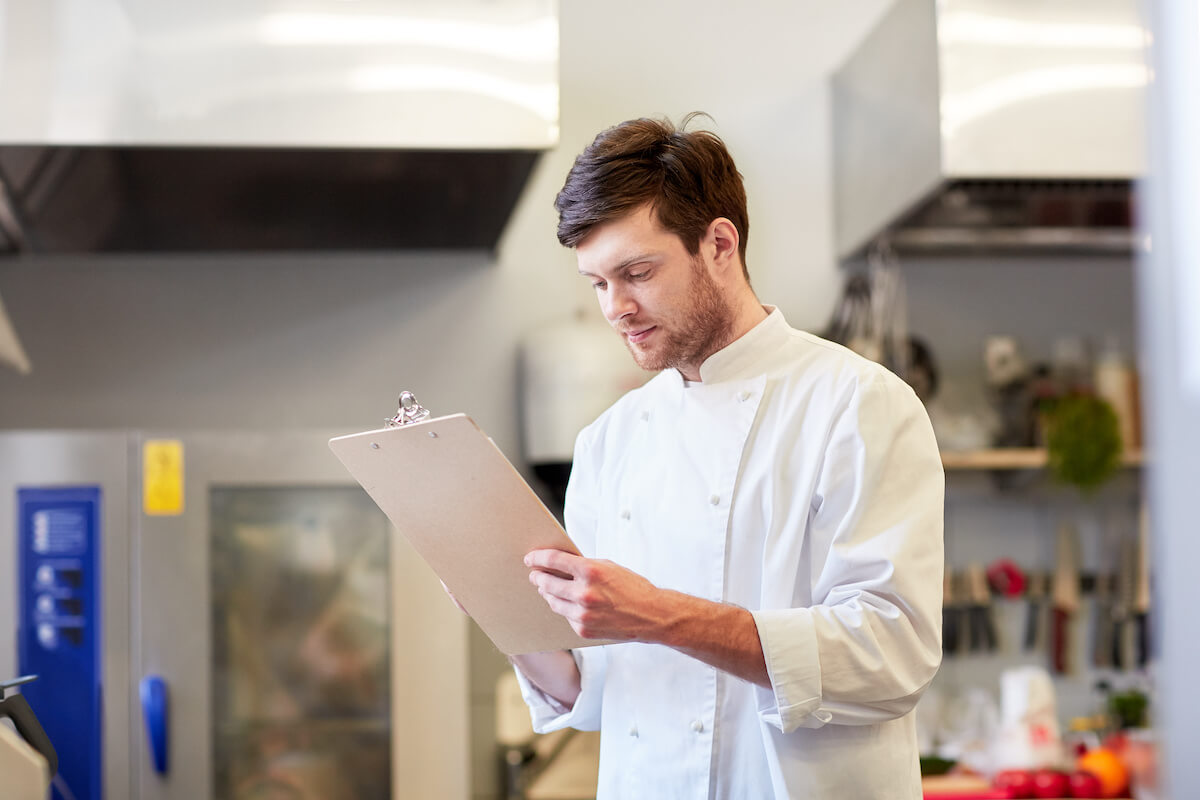 Comping a meal: chef holding a clipboard