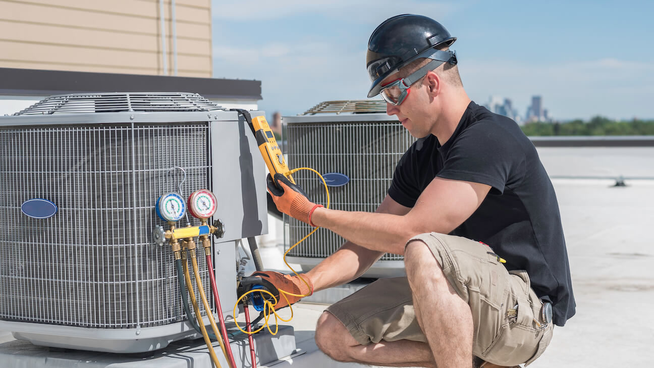 Free HVAC leads: HVAC technician checking an air conditioning system