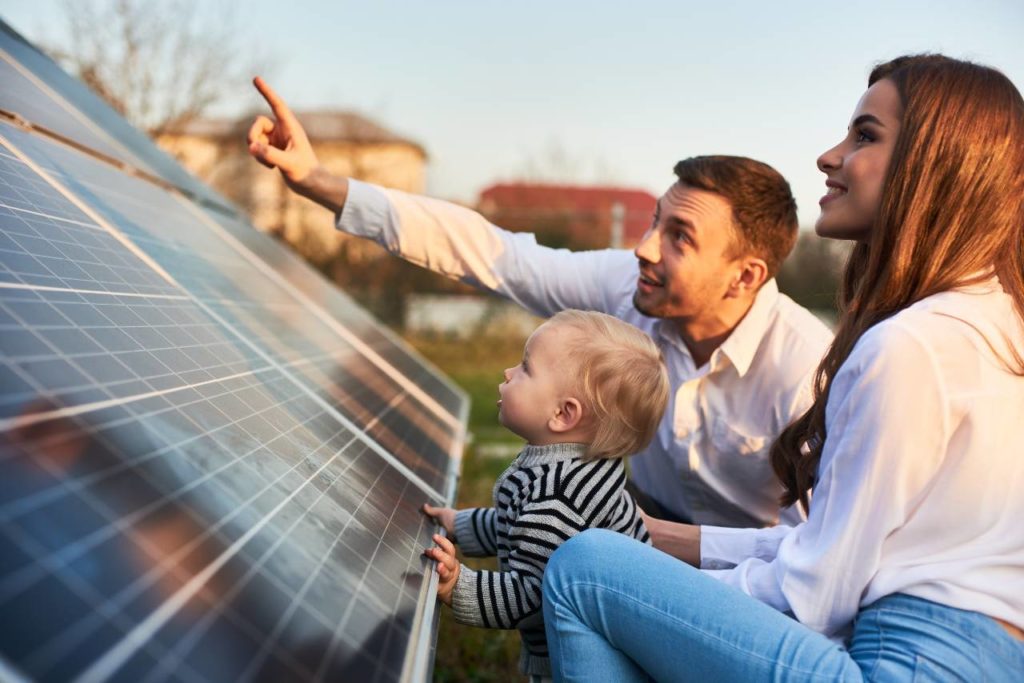 Parents with toddler looking at solar panels