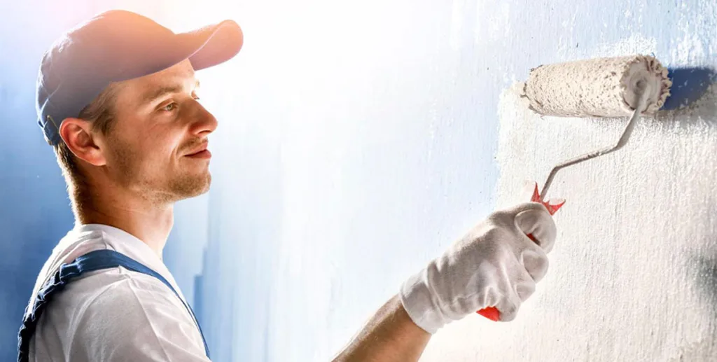 painter painting a wall with paint roller