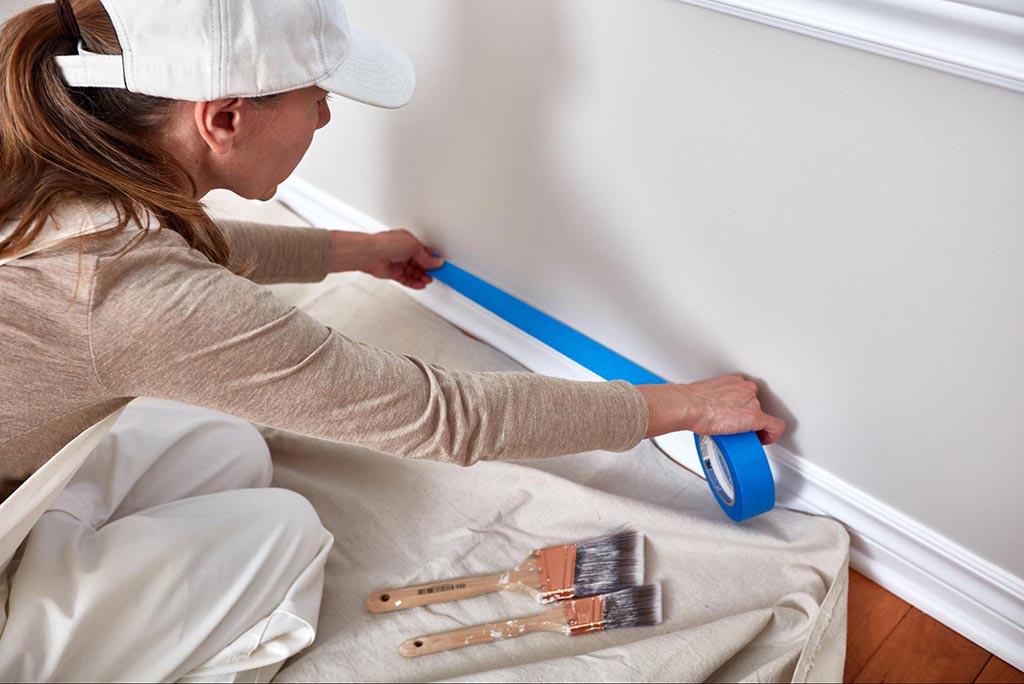 How to get painting leads: painter putting down masking tape
