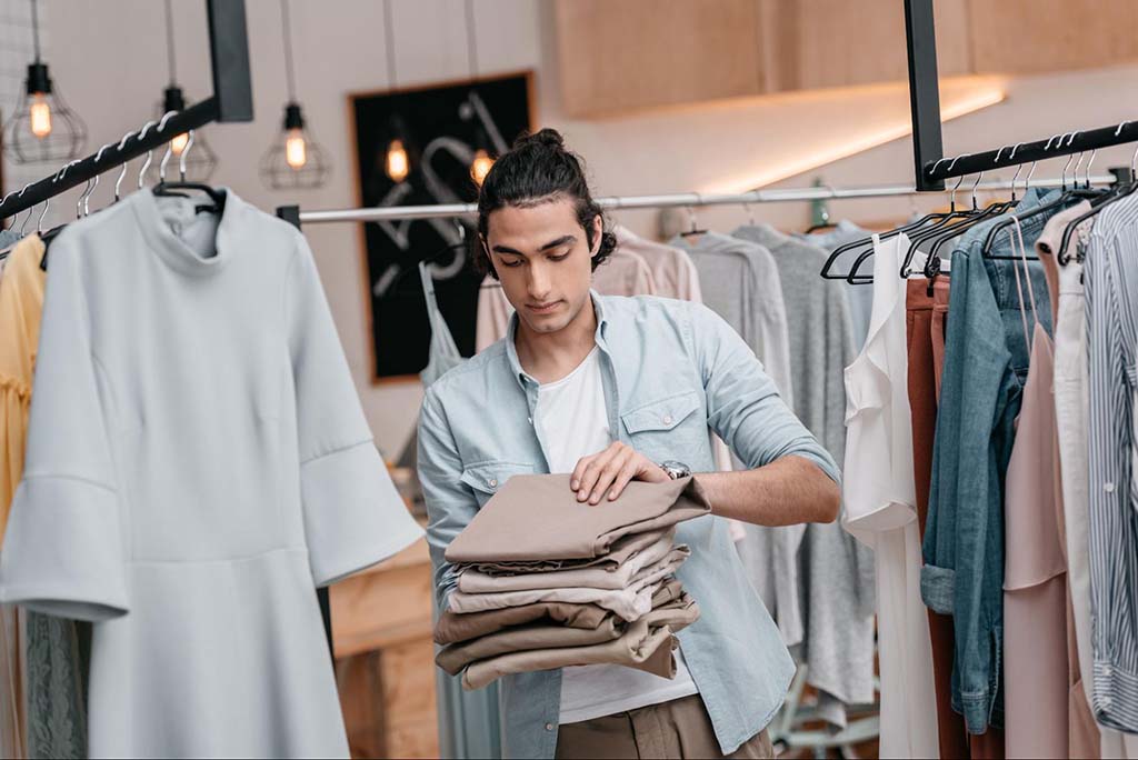 Boutique shop worker folding clothes