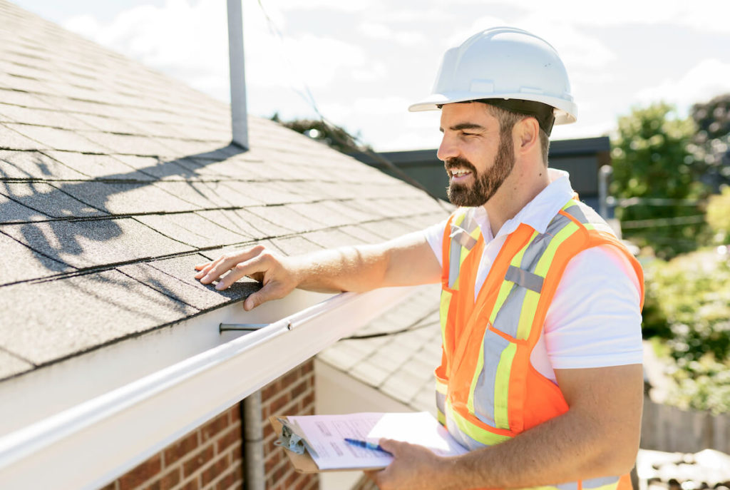 Roofing advertisement: roofer happily checking their work
