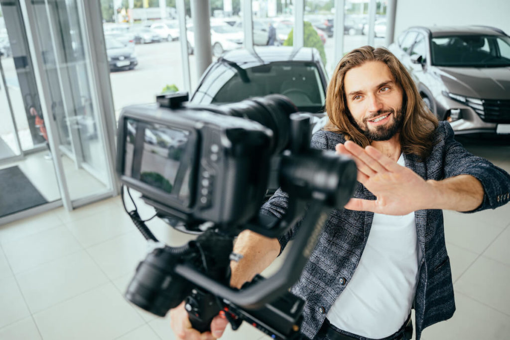 Auto leads: influencer recording a video of himself at a showroom