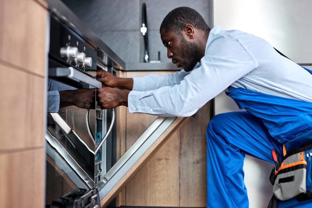 Appliance repair leads: Repair man fixing a broken dishwasher