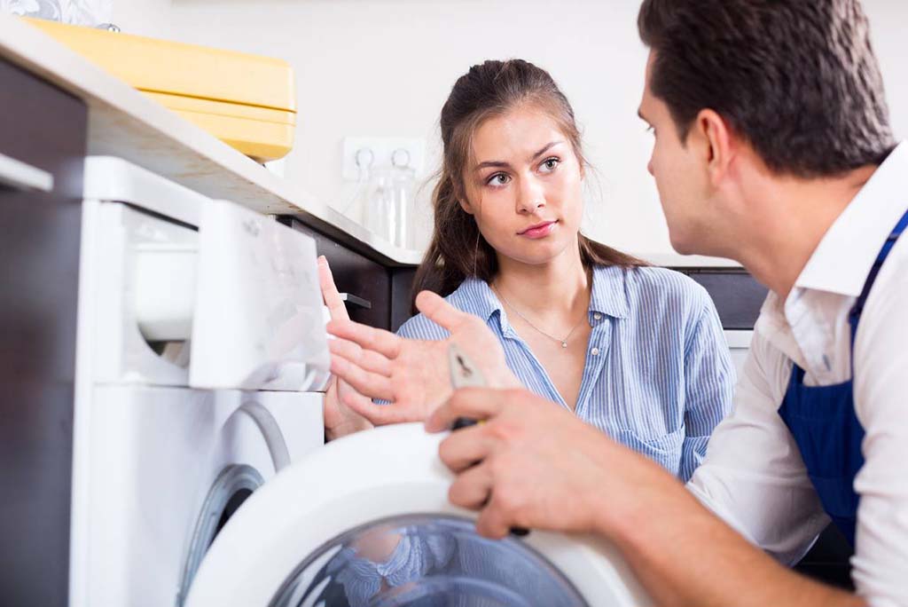 Appliance repair leads: Specialist repairing a clothes dryer
