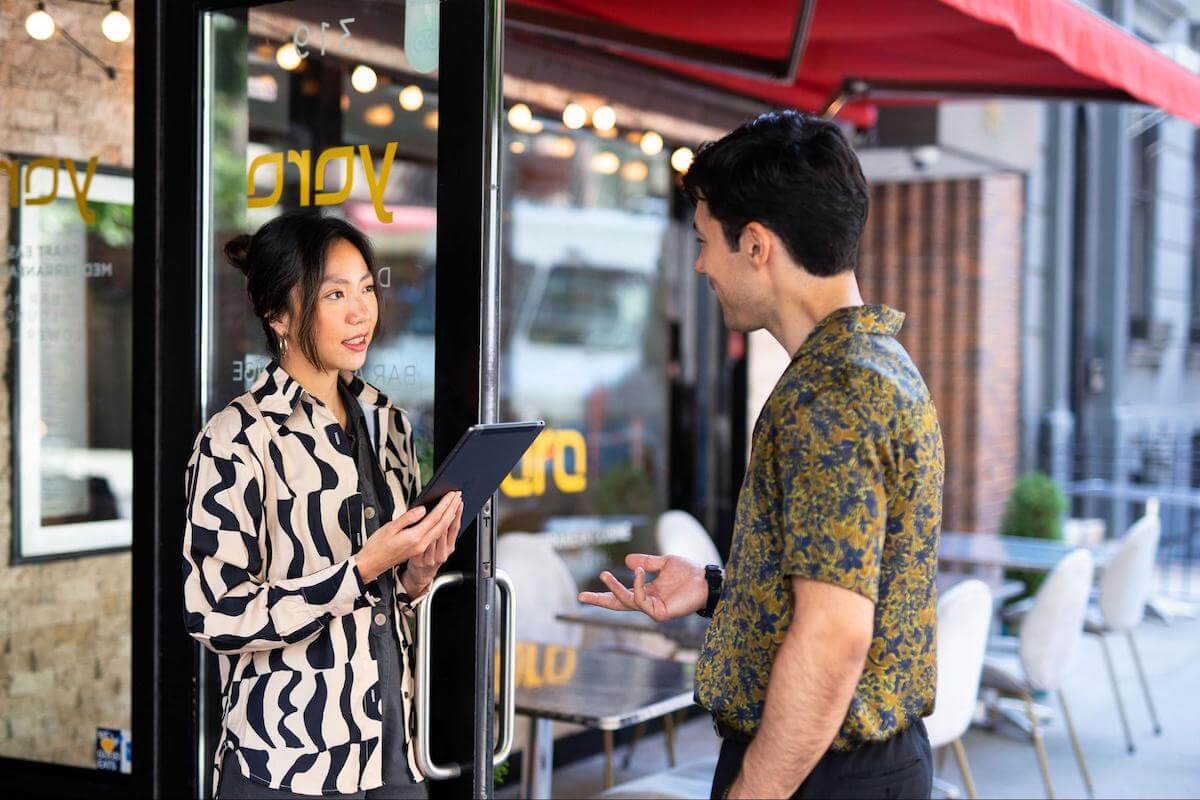 Restaurant business plan: restaurant manager talking to a customer