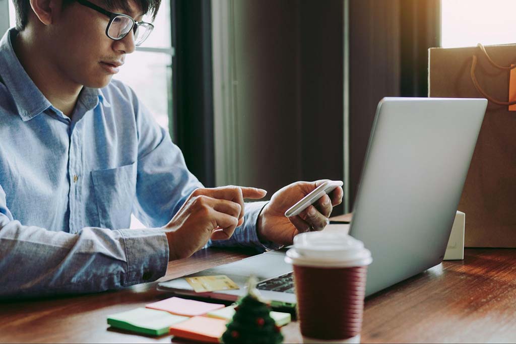 https://business.yelp.com/wp-content/uploads/2023/02/man-sitting-in-cafe-searching-for-coupon-codes-using-his-laptop.jpg