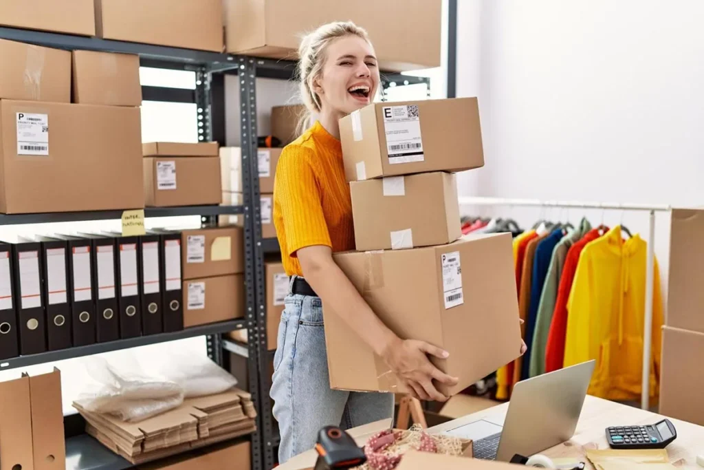 Clothing boutique owner arranging stock boxes