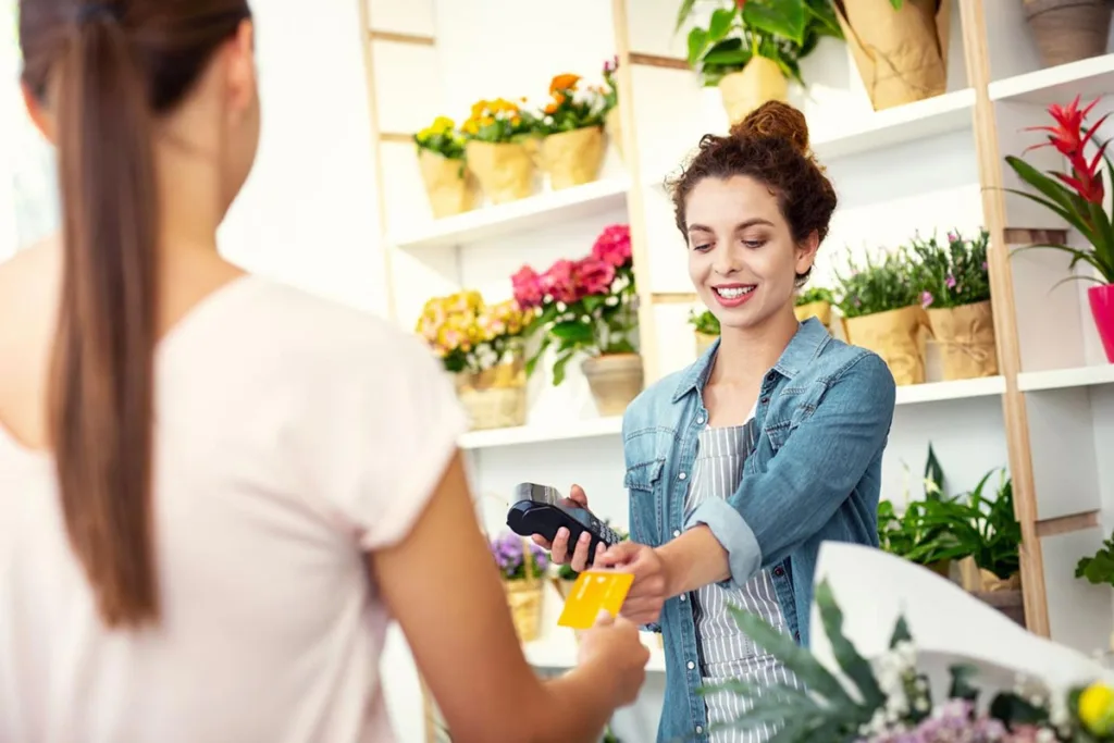 Florist accepting credit card payment from customer