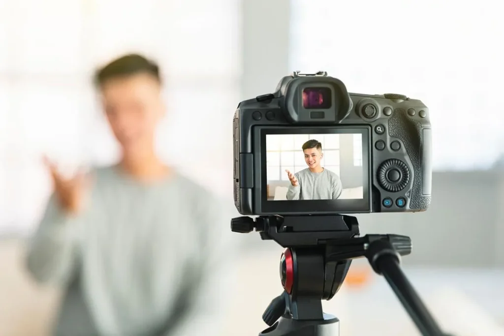 A young man filming a TikTok video