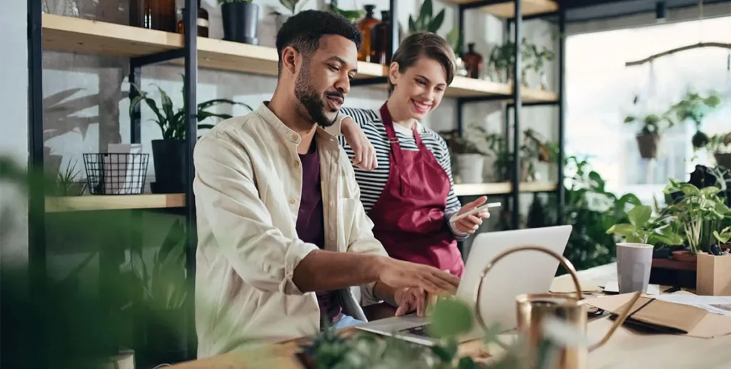 What is a lead: flower shop owners using laptop at counter