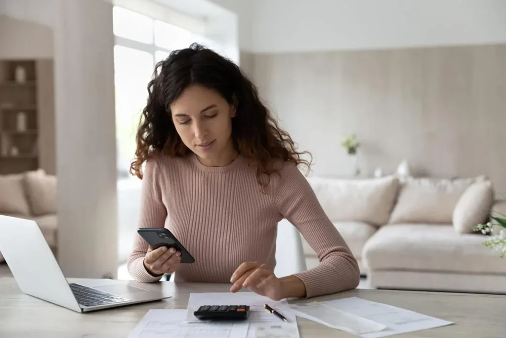 Business owner using phone to calculate maximum CPC for ad campaign