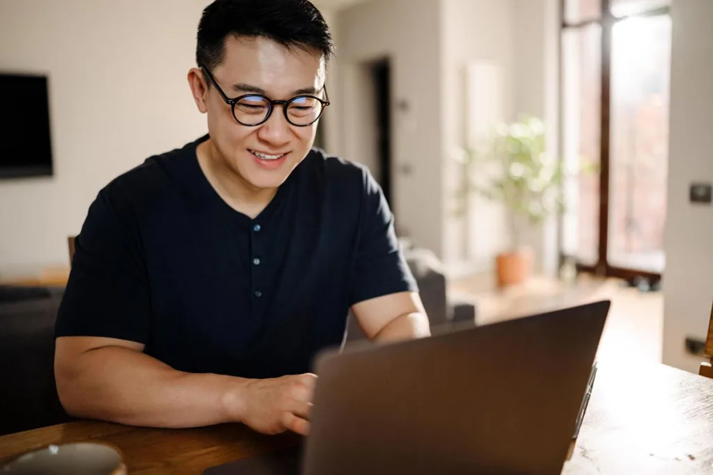 Man using laptop to check social media advertising ideas