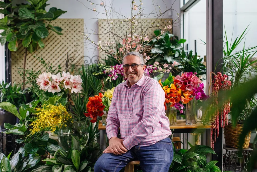 Nic Faitos, owner of Starbright Floral Design, sitting inside his store