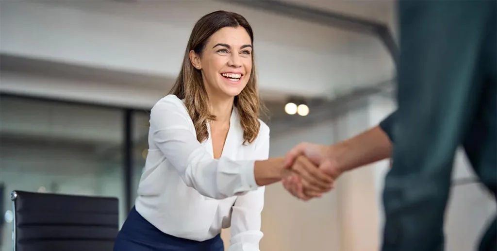 Businesswoman shaking hands in meeting