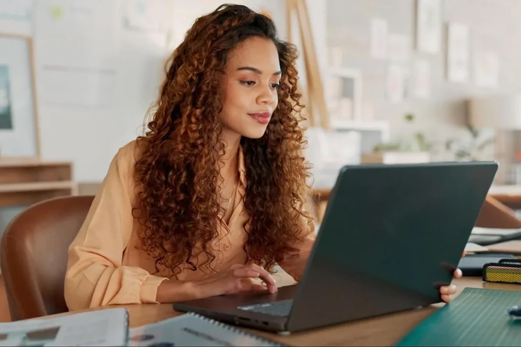 Marketing manager setting up an email campaign using her laptop