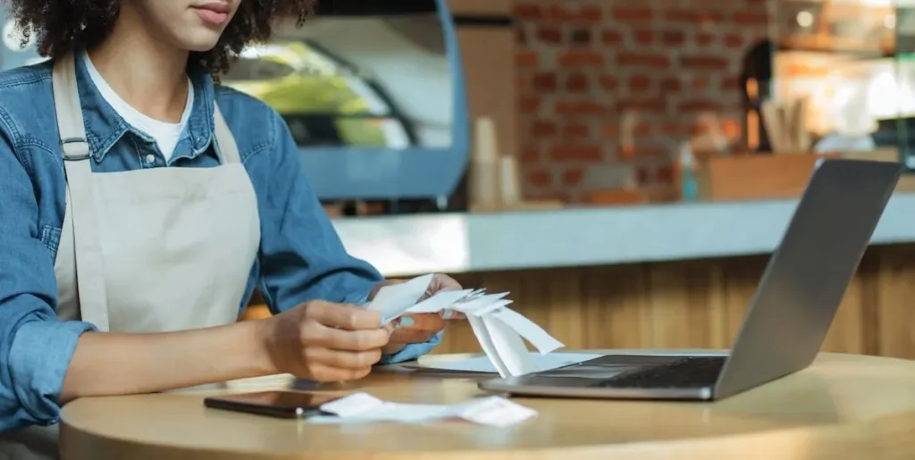 Restaurant owner looking at receipts